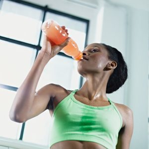 african woman in gym drinking energy drinkAfrican Woman In Gym Drinking Energy Drink